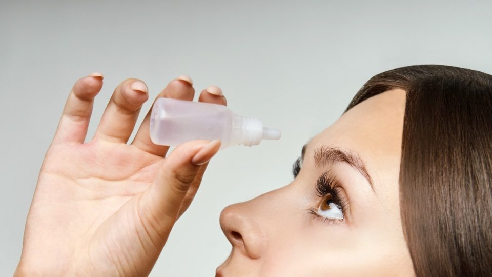 Girl using eye drops. Anti glaucoma recovery. Healthy medicine solution. Woman hand near face. Tears ophthalmology treatment. People healthcare. Clean water.