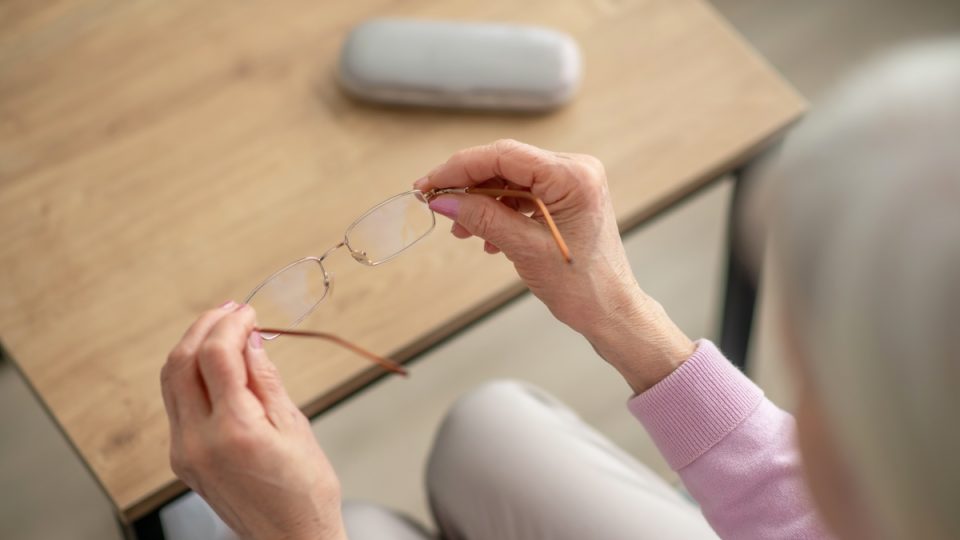 Eyeglasses. Close up picture of womans hands with eyeglasses